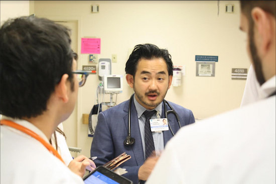 Dr. Charles Okamura discusses patient care with fellow NYU Lutheran physicians. Courtesy of NYU Lutheran