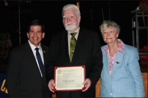 Commodore Barry Club Treasurer Peter Lovett (center) receives a City Council certificate from Councilmember Vincent Gentile at the club’s recent tea social. At right is President Mary Nolan. Photo courtesy of Commodore Barry Club