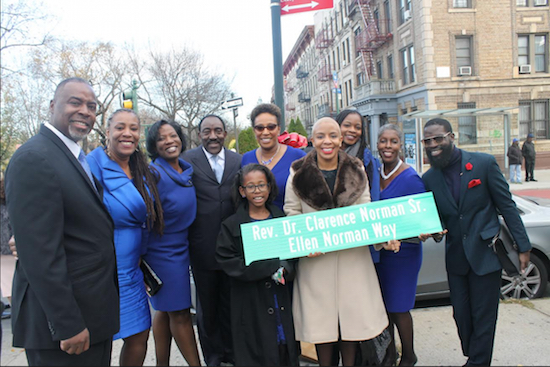 Proudly displaying the new street sign co-naming the corner of Eastern Parkway and Rogers Avenue "Rev. Dr. Clarence Norman Sr. Ellen Norman Way" are the couple's family members and Councilmember Laurie Cumbo, from left: Charles Thomas, Kendra Norman, Dawn Norman, Clarence Norman Jr., Maia Parker, Beverly Norman Thomas, Cumbo, Jennifer Norman, Kimberly Fortune and Jermaine Joseph. Photo courtesy of the office of City Councilmember Laurie Cumbo