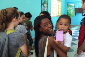 A student from St. Edmund Prep makes a new friend at a day care center in Cuba. Photo courtesy of St. Edmund Prep