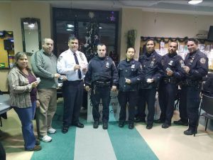 Renee Giordano (left) and Delvis Valdes (second from left) of the Sunset Park BID present Challenge Coins to the 72nd Precinct. Photos courtesy of Tony Giordano