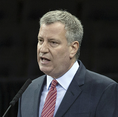 NYC Mayor Bill de Blasio announced a plan on Tuesday to enroll tens of thousands of city residents in health insurance plans by the end of January. AP file photo by John Minchillo