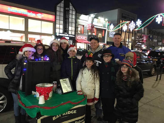 The Lemonade Coalition got some help from grownups like Capt. Joseph Hayward, commanding officer of the 68th Precinct, in their fundraising efforts on 86th Street Friday night. Photo courtesy of Reaching Out Community Services Inc.