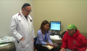 Dr. Arkadiy Izrailov and Chanell Perez discuss wellness strategies with Frank Rollo (right). Photo courtesy of Visiting Nurse Service of New York