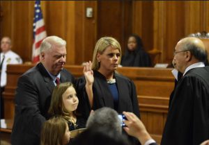 Hon. Susan Quirk being sworn in by Hon. Randall T. Eng, presiding justice of the Appellate Court, Second Department with her father Dennis Quirk and two daughters Annadoreen and Antonia Lanni looking on. Eagle photo by Rob Abruzzese