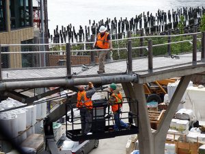 After being shut down more than two years ago, the lawsuit over “bouncy” Squibb Park Bridge, zig-zagging downward from Brooklyn Heights to Brooklyn Bridge Park, continues. Shown: An engineering team assesses the stability of the bridge in this photo taken last July. Photo by Mary Frost