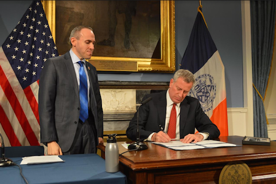 Councilmember Mark Treyger looks on as Mayor Bill de Blasio signs the bill he introduced to boost the city’s Career Technical Education (CTE) programs. Photo courtesy of Treyger’s office