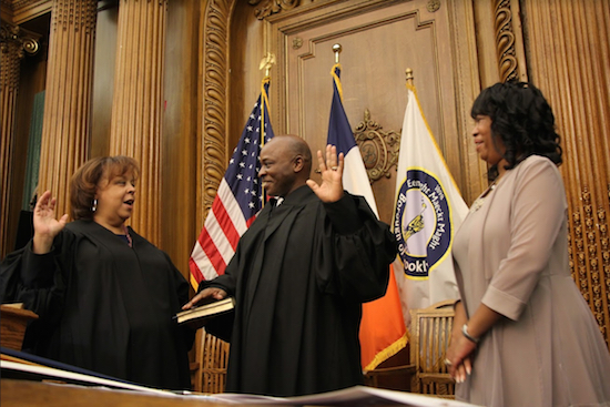 Hon. Reginald Boddie is sworn in by Hon. Fern A. Fisher, Deputy Chief Administrative Judge, NYC Courts, as his wife Charisse Boddie looks on. Eagle photos by Mario Belluomo