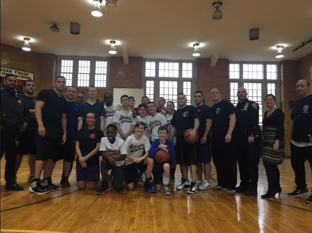 Pictured: Karen Ditolla, the principal at Mark Twain for the Gifted & Talented (2nd from the right), officers of the 60th Precinct and the Mark Twain 8G Athletics Talent students. Photo by Roseann DeVito