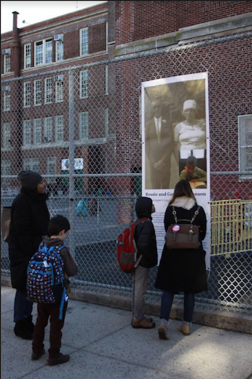 Families stop along the sidewalk outside P.S. 10 to view the Diversity Project installation. Photo: Shia Levitt