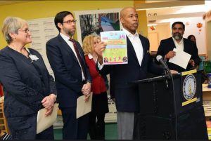 Borough President Eric Adams (at podium) and state Sen. Daniel Squadron (second from left) presented a report from their Early Childhood Development Task Force at Magical Years Early Childhood Development Center in Sunset Park, standing alongside members of their task force. Photo: Erica Sherman/Brooklyn BP’s Office