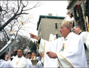 Bishop Nicholas DiMarzio blesses and lights the torches to be used in processions throughout Brooklyn on Dec. 12, 2015, in celebration of Our Lady of Guadalupe, the patron saint of Mexican-Americans. The festivities began with dancing in the plaza outside the Co-Cathedral of St. Joseph in Prospect Heights. Eagle file photo by Francesca N. Tate