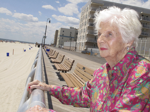 FILE- In this July 22, 2015 file photo, Lucille Horn stands on the boardwalk outside her home in Long Beach, N.Y. Horn who weighed less than two pounds at birth and wasn't expected to survive, lived nearly a century after her parents put their faith in a sideshow doctor at Coney Island who put babies on display in incubators to fund his research to keep them alive. She died in New York at age 96 on Feb. 11, 2017. AP Photo/Frank Eltman
