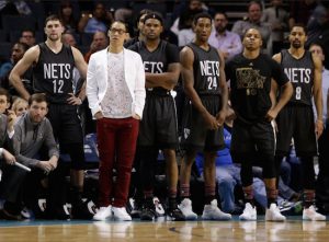 Nattily dressed former Hornet Jeremy Lin and his teammates look on as the Nets suffer their 10th straight defeat in Charlotte on Tuesday night. AP Photo by Chuck Burton