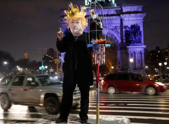 A man dressed as President Donald Trump stands on a slab of concrete at Grand Army Plaza during a demonstration in what was billed as the first in a series of "Resist Trump Tuesdays” on Tuesday. AP Photos/Kathy Willens