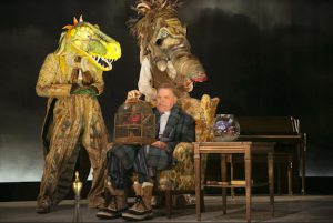 There's a dino-mite new production of "The Skin of Our Teeth" at Theatre for a New Audience's Polonsky Shakespeare Center. A dinosaur, at left, played by Fred Epstein, shares a moment with Mr. Antrobus, center, played by David Rasche, and a mammoth, at right, played by Eric Farber. Photo by Gerry Goodstein