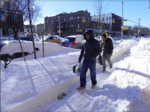 Pedestrians make their way along a shoveled Bensonhurst sidewalk following a 2016 snow storm. Eagle file photo by Paula Katinas