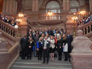 Led by President and CEO Andrew Hoan (front and center), the delegation from the Brooklyn Chamber of Commerce enjoys the view from the majestic staircase inside the State Capitol in Albany on March 13 during a day packed with meetings with top officials. Eagle photo by Paula Katinas