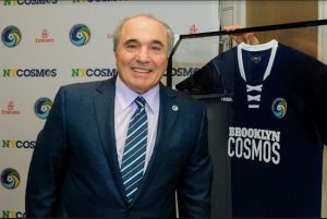 Cosmos Chairman Rocco B. Commisso poses in front of a “Brooklyn Cosmos” jersey that was given to him by the Brooklyn Chamber of Commerce. Eagle file photo by Arthur De Gaeta