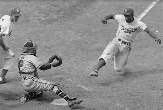 Brooklyn Dodgers great Jackie Robinson, who's stealing home plate in this 1948 photo, lived in East Flatbush in the late 1940s. AP Photo
