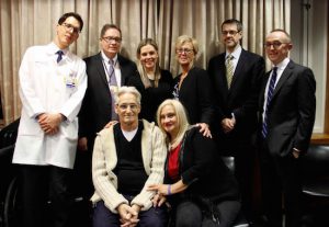 LVAD recipient Henry Scarpati and his wife Patricia (seated) said they are grateful to the Maimonides team: Dr. Aleksandar Adzic, Dr. Gregory Crooke, LVAD Program Coordinator Rivka Mintz, Registered Nurse Lorraine Carroll, Dr. Norbert Moskovits and Dr. Paul Saunders(left to right). Photo courtesy of Maimonides