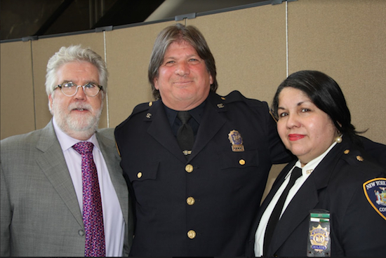 Mark Campbell (center), the Kings County court officer has patrolled the judge's parking lot outside of the Supreme Court for the past 15 years, was named Court Employee of the Year during a special ceremony. Pictured with John T. Dougherty (left) and Major Luz Bryan (right). Eagle photos by Mario Belluomo