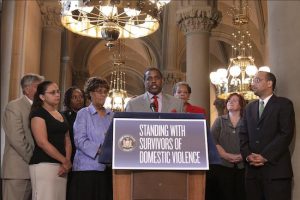 State Sen. Kevin Parker (at podium) with domestic violence prevention advocates, says his aim is to reduce the number of incidents in New York State. Photo courtesy of Parker’s office