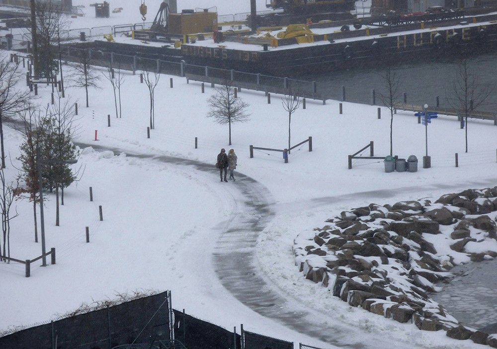 This couple ignored the blasting wind and sleet to enjoy a nice walk in Brooklyn Bridge Park.