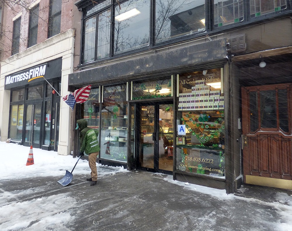 Lassen & Hennings, founded in 1939, was one of the first shops on Montague Street to shovel its sidewalk on Tuesday.