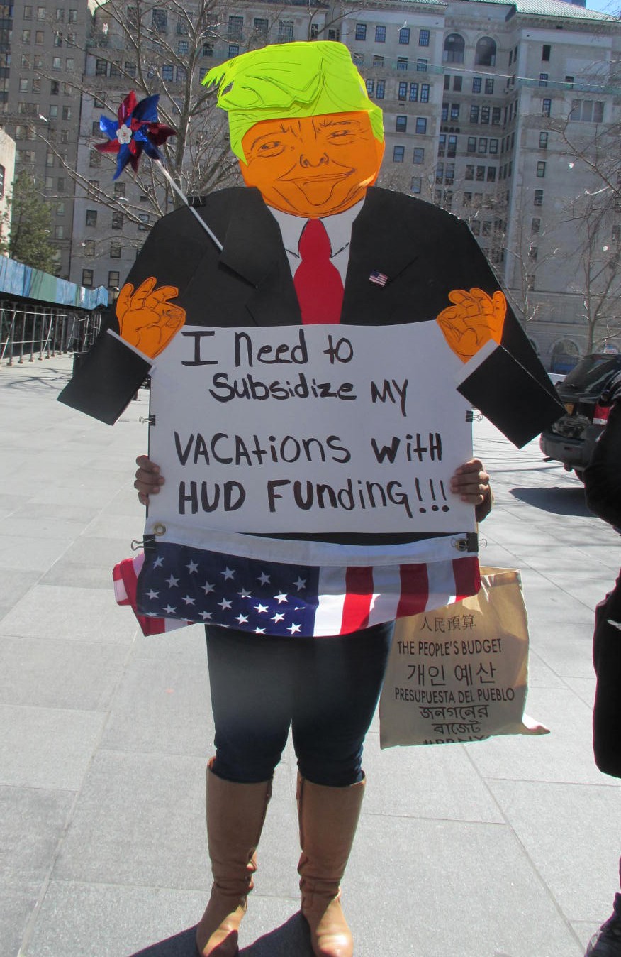 A protester holds a parody sign of President Trump bearing the words, “I need to subsidize my vacations with HUD funding!!!” Photos courtesy of Ellen Freudenheim