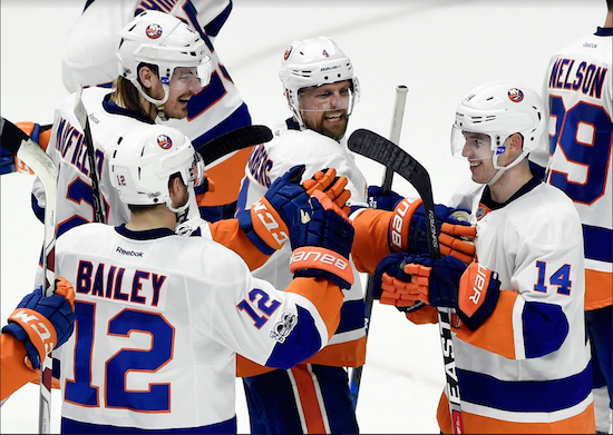 Thomas Hickey (right) receives congratulations from teammates after saving the Islanders’ season for at least another couple of days with a game-winning overtime goal in Nashville on Tuesday night. AP Photo by Mark Zaleski