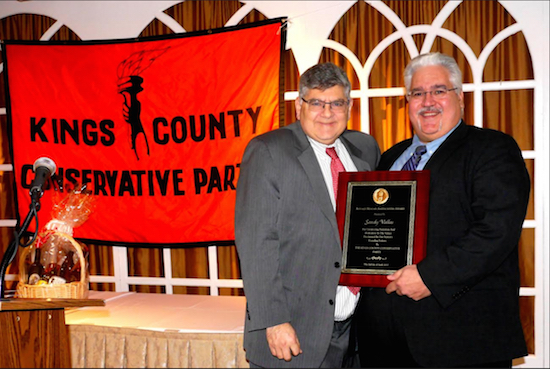 Kings County Conservative Party Chairman Jerry Kassar (left) presents Sandy Vallas with the Ronald Reagan American Humanism Award. Eagle photos by Arthur Da Gaeta