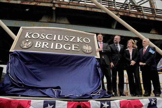 New York Gov. Andrew Cuomo, left, unveils the original name plaque for the new Kosciuszko Bridge. AP Photos/Julie Jacobson