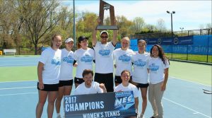 First-year LIU Brooklyn women’s head tennis coach Anthony Davison raises the championship trophy for his team Sunday in West Windsor, N.J., after the Blackbirds completed an historic turnaround by clinching a berth in next month’s NCAA Tournament. Photo courtesy of LIU-Brooklyn athletics