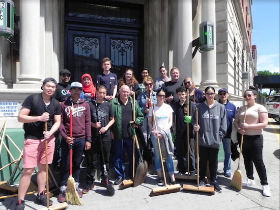 Volunteers gathered outside the 62nd Precinct station house on Bath Avenue to get their brooms and shovels for the cleanup. Eagle photo by Paula Katinas