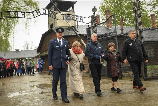 Holocaust survivor Bronia Brandman (second from right) walks through the front gate of the Auschwitz death camp with Brig. Gen. Zvika Haimovich, Holocaust survivor Giselle Cycowicz, Friends of the Israel Defense Forces National VP Robert Cohen, and Maj. Gen. Meir Klifi-Amir (left to right). Photos by Shahar Azran