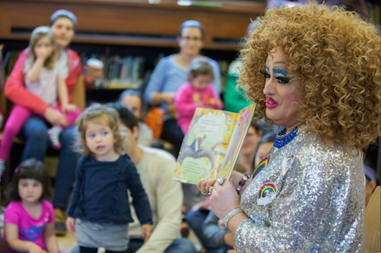 In this Saturday, May 13, 2017 photo, Lil Miss Hot Mess reads to children during the Feminist Press' presentation of Drag Queen Story Hour at the Park Slope Branch of the Brooklyn Public Library. About once a month since last fall, the Brooklyn Public Library has been presenting Drag Queen Story Hour, where performers with names such as Lil Miss Hot Mess and Ona Louise regale an audience of young children and their parents. AP Photos/Mary Altaffer