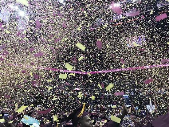Brooklyn College graduates celebrate in waves of confetti at the Barclays Center. Eagle photo by Paul Frangipane