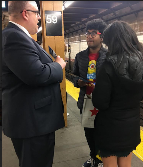 Democrat Justin Brannan, pictured with riders at the 59th Street R train station, recently spoke to a grassroots progressive organization. Photo courtesy of Brannan campaign