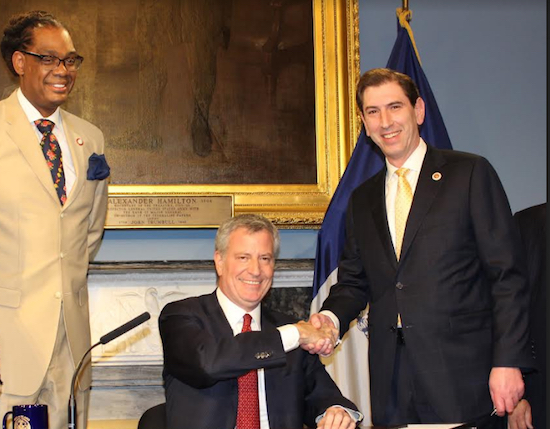 Councilmember Chaim Deutsch (right) says the new law he crafted will help first responders get to emergency scenes faster. The bill was signed by Mayor Bill de Blasio. At left is Councilmember Robert Cornegy Jr. Photo courtesy of Deutsch’s office