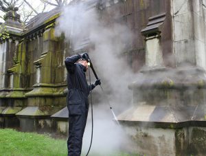 Cultural restoration expert Thorsten Moewes of German cleaning equipment company Kärcher steam cleans one of Green-Wood Cemetery’s historic mausoleums. Photo courtesy of Kärcher