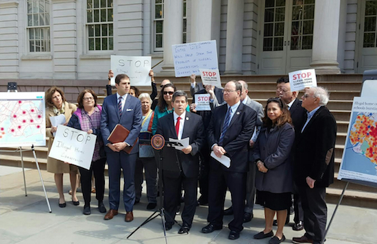 Councilmembers Vincent Gentile (at podium) and Barry Grodenchik (right of Gentile) gather outside City Hall Wednesday to mark the passage of their legislation to protect tenants. Photo courtesy of Gentile’s office