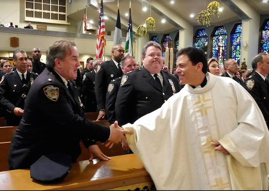 Msgr. Jaimie Gigantiello shakes hands with Deputy Chief Charles M. Scholl, executive officer of operations at Patrol Borough Brooklyn South. Eagle photos by Arthur De Gaeta