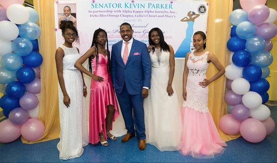 Senator Kevin Parker surrounded by students the prom drive in their dress selection. Photo Credit: Solwazi Olusola