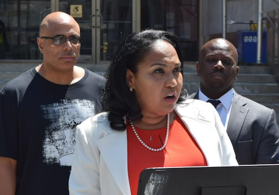 Brooklyn DA candidate Ama Dwimoh (second from left) stands in front of Shabaka Shakur (left) and Jabbar Collins (right), a pair of Brooklynites who spent a combined total of 43 years in prison for crimes that they did not commit, as she calls for systemic changes to the DA’s Office. Eagle photo by Rob Abruzzese