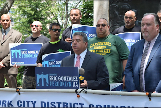 Acting District Attorney Eric Gonzalez (center) stands next to Steve McInnis (far right) in front of members of the NYC District Council of Carpenters union on Thursday as he pledged to hold real estate developers accountable for safe construction sites. Eagle photo by Rob Abruzzese