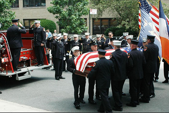 Firefighters carry Gormley’s casket and salute the fallen hero. Eagle photos by Arthur De Gaeta