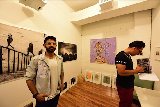 Artist Harsha Biswajit (left) in his first-floor Java Studios studio with visitor Mike. Eagle photos by Andy Katz