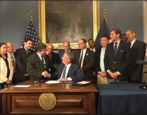Mayor Bill de Blasio congratulates Councilmember Vincent Gentile (left) at the ceremony marking the signing of the bill. Photo courtesy of Gentile’s office