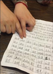 After joining the loan club, members receives a handwritten “contract,” like this, specifying the club’s terms and members’ names in a grid hand-drawn by the fund managers. Eagle photo by Jane Yi Zhang